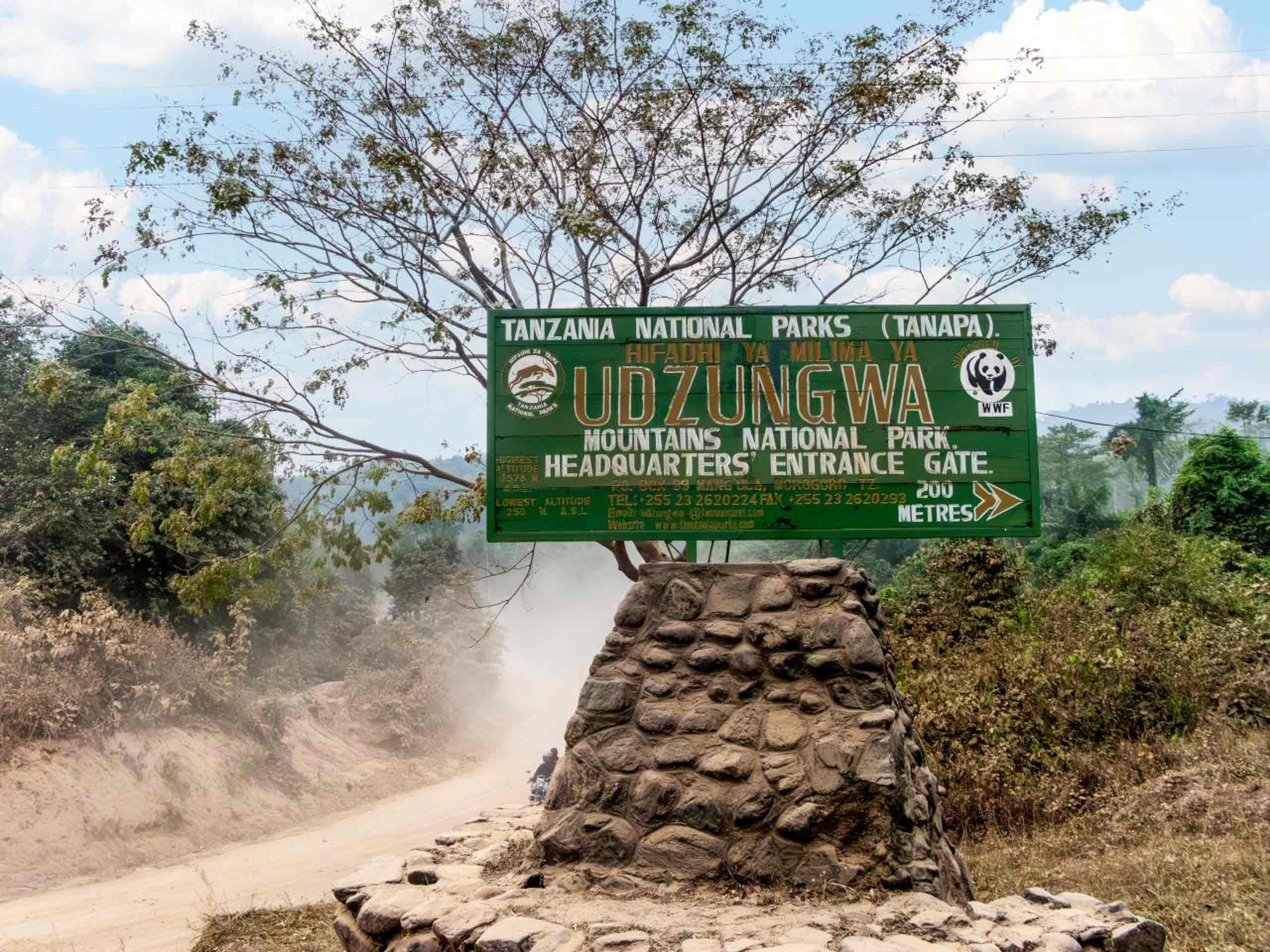 Udzungwa Mountains National Park entrance gate sign in Tanzania surrounded by natural forest landscape